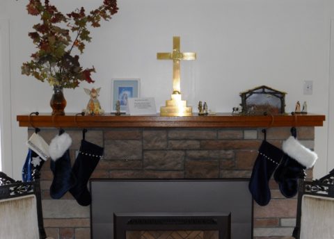 A combination of Nativity set placed and stockings hung on the parish hall hearth.